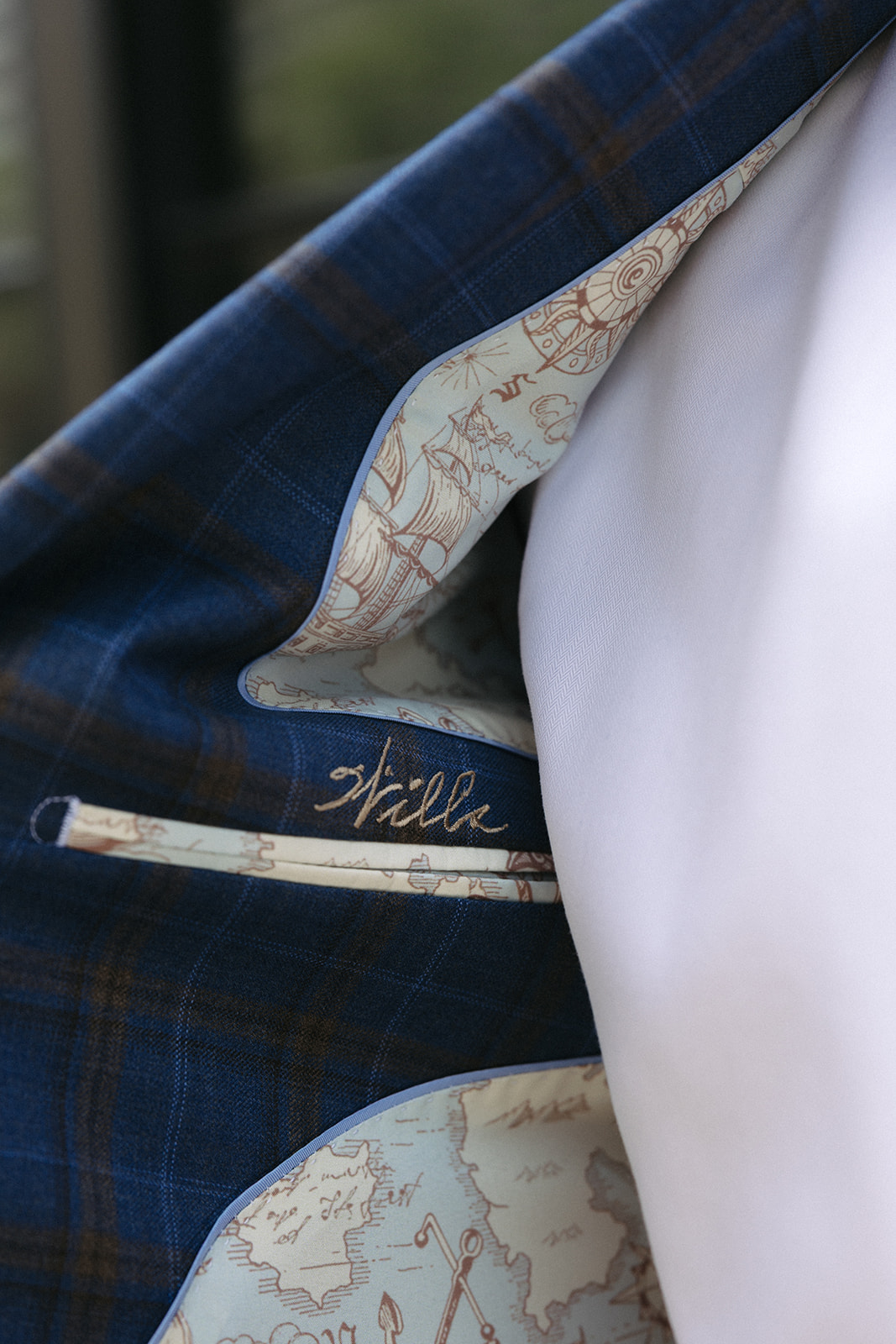Personalized name label stitched into a custom jacket with map-print lining