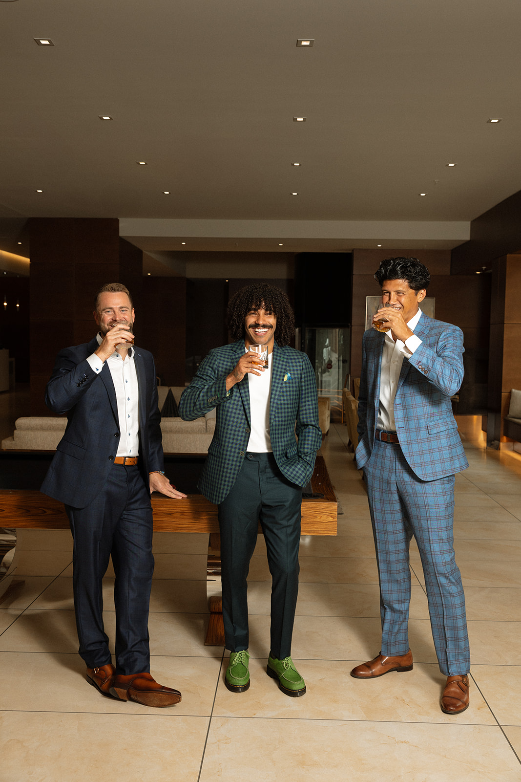 Three men in custom suits raising a toast