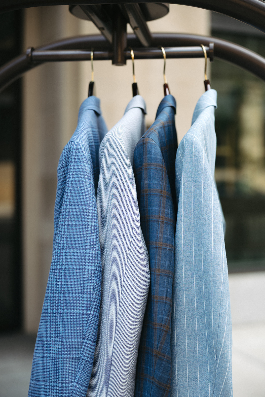 Finished custom jackets hanging on a rolling rack