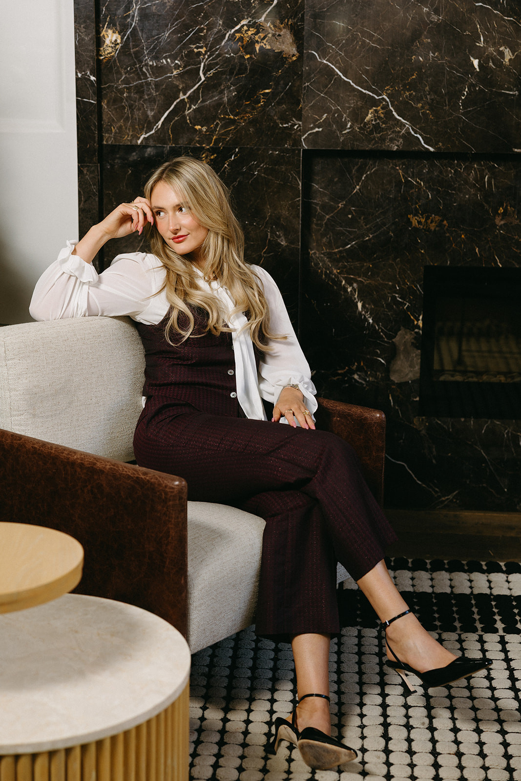 Woman in a custom white blouse and burgundy trousers
